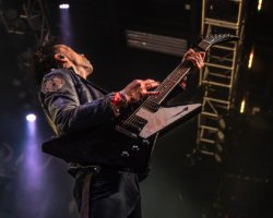 Jamel Hawke of Boys Like Girls playing his blood streaked guitar after tearing his finger open during a performance at the Fillmore Silver Spring